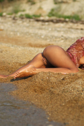 Brunette is nude on the beach and in the water